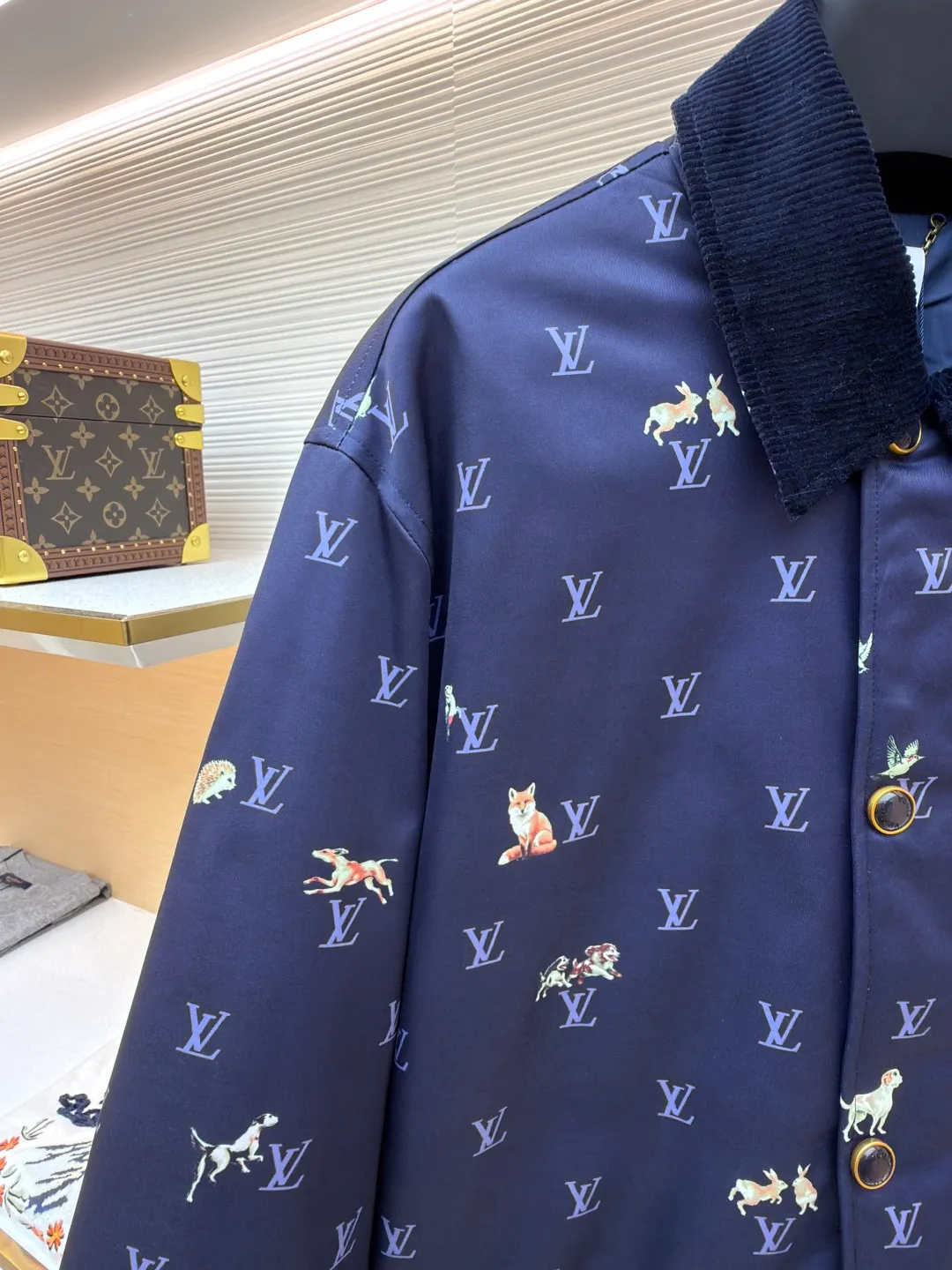 LOUIS VUITTON corduroy lapel animal print jacket ●Original version: 25500 purchased and developed ●Item number: 1681800-C00 ●Fabric: high-density polyester nylon fabric ●Technology: digital direct printing ●Color: blue ●Type: fitted version ●Weight: about 805 grams ●Size: 46-48-50-52 ●Description: This LOUIS VUITTON corduroy lapel jacket is made of high-density twill fabric base, and the surface is combined with corduroy texture splicing, taking into account both stiffness and soft touch. The body pattern uses digital direct printing technology to accurately print the LV logo and animal elements on the fabric. The color is full and not easy to fade. The collar is made of contrasting corduroy material, and the positioning and cutting process is used to ensure the alignment of the splicing; the front placket is equipped with metal buttons, and the surface of the buttons is matte-plated for a refined and durable texture. The version has a loose lapel design, and the shoulders and armholes are three-dimensionally cut, with precise stitching to improve the fit. The overall process pays attention to the details of pattern positioning and fabric splicing. The edges are overlocked to take into account brand recognition and practical wearability. It is recommended to hand wash to protect the printing and fabric texture. The overall wiring is straight and delicate, the fabric is comfortable and soft, and the color is consistent without color difference. It can be matched with the same style to create a fashionable look and control various occasions. Customized accessories, complete with three standards, same style for men and women!